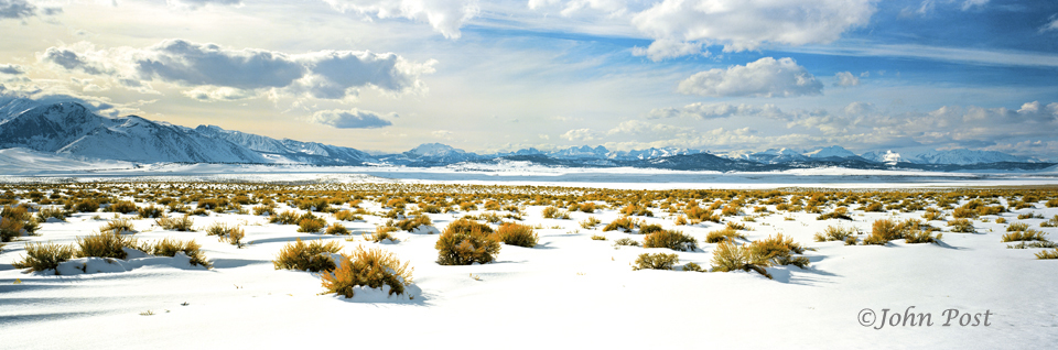 View accross snowfield towards Sierra mountains, clear blue sky