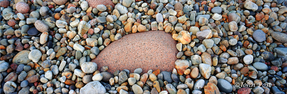 Worn beach rocks of various sizes and shapes and colors.
