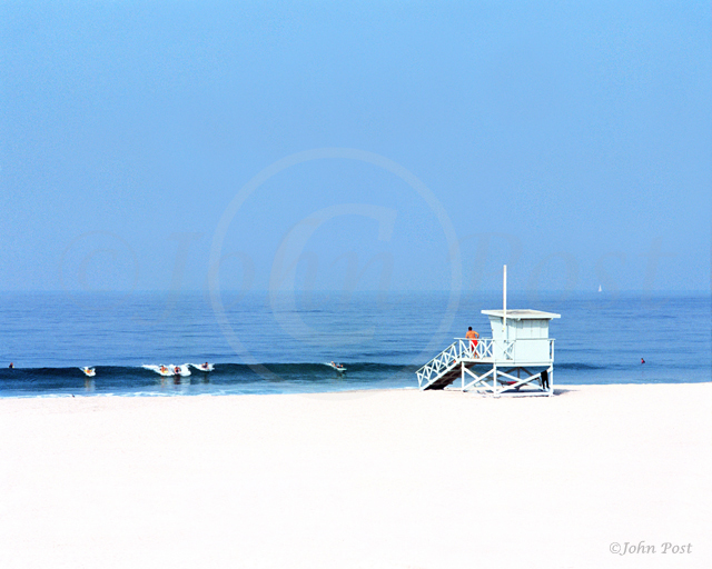 Summer beach scene with surfers and lifeguard