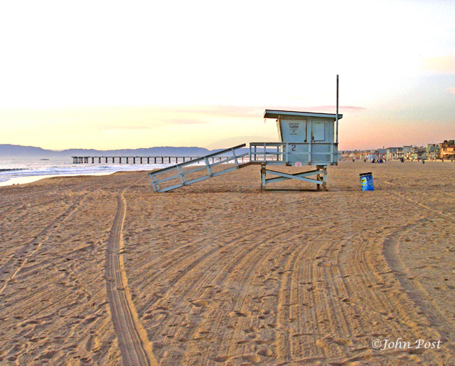 Lifeguard tower on beach, clear sunset sky